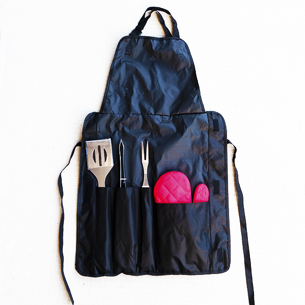 Tough barbecue apron with barbecue tools and glove