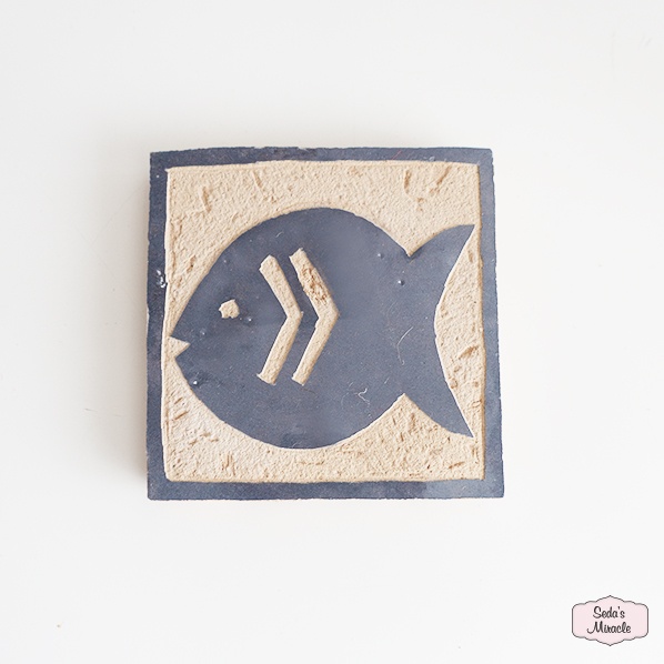 Handmade and hand-carved Moroccan zellig tile of pottery fish, blue